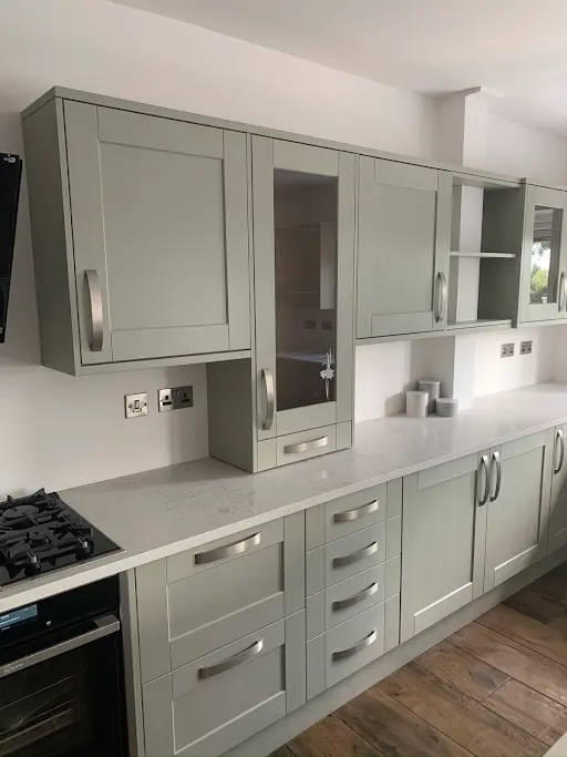 Bespoke sage green shaker fitted kitchen with tall larder units, Bexley